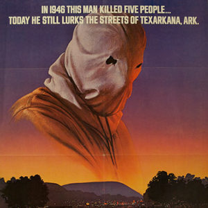 Man in hood with eye holes and town on movie poster