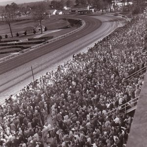 View of racetrack from bleachers packed with people