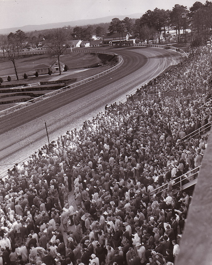 View of racetrack from bleachers packed with people