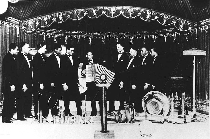 African-American men in matching suits performing on stage
