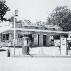 Single-story service station with two gas pumps outside it