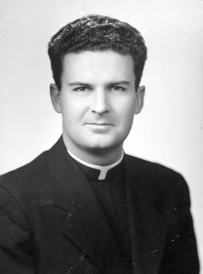 Young white man in black clerical outfit with white collar