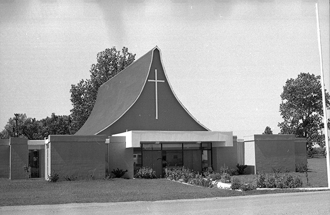 Single-story building with cross on tented roof
