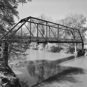 Steel truss bridge and adjacent concrete bridge over river