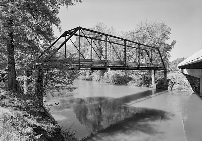 Steel truss bridge and adjacent concrete bridge over river