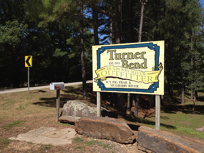 "Turner Bend" sign with rock barriers and mail box and road sign