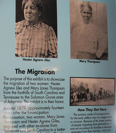 Photographs of African-American women and wagon train on "The Migration" interpretation panel