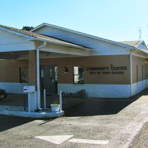 Single-story "Community Center" building with car parked under covered entrance