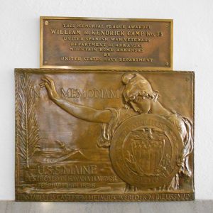 Bronze plaque for "William R. Kendrick Camp No. 13" above a bronze plaque depicting a woman holding a shield
