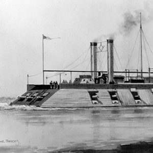 Ironclad boat on water with flag