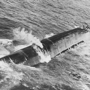 Capsized Naval ship sinking into the ocean