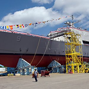 Naval ship in cradle being dressed with flags and streamers