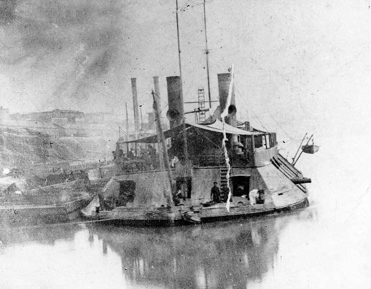 Close-up view of naval steamboat on river with sailors on deck
