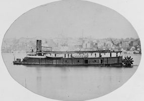oval-shaped photo of the Side view of naval steamboat on river