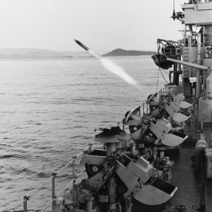 Rocket being fired from deck of Naval vessel