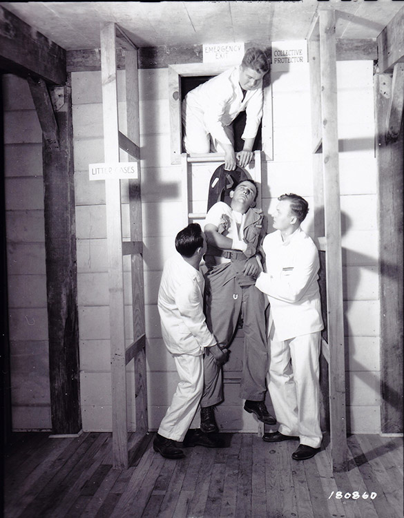 White doctors lifting a patient up a ladder to an emergency exit
