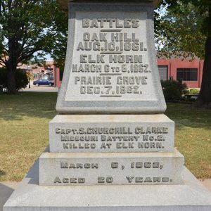 Raised engraving on pedestal base listing battle sites and dates