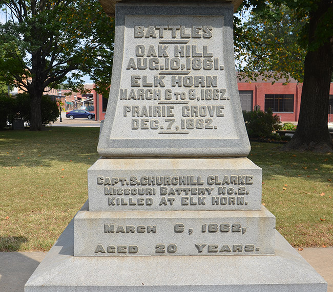 Raised engraving on pedestal base listing battle sites and dates