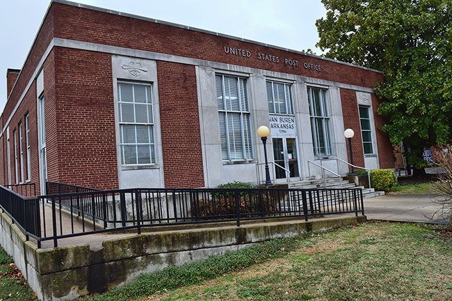 Brick post office building with wheelchair ramp and railing