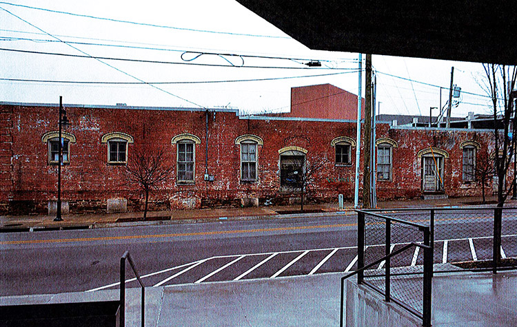 Side view of brick warehouse building from building across the street