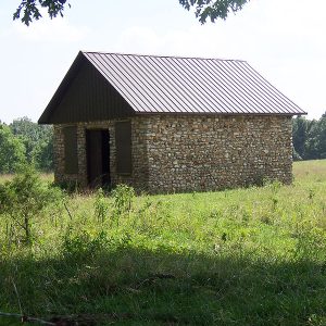 Brick building with new roof in field