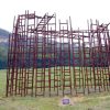 Interlocking ladders standing in a field with mountains in the background