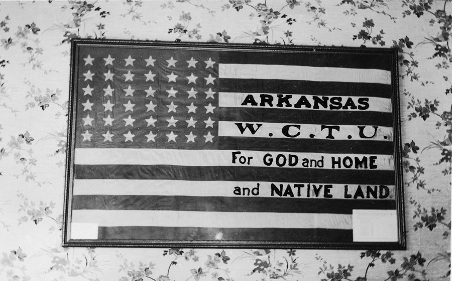Framed American flag with "Arkansas W.C.T.U. for God and Home and Native Land" written on its white stripes
