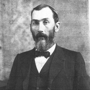White man with beard in suit and bow tie