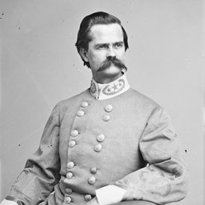 White man with mustache in gray military uniform sitting in chair