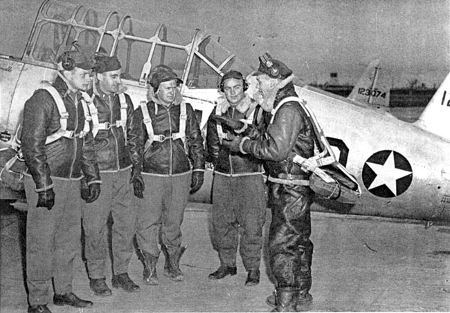 White men in pilot's uniforms with airplane