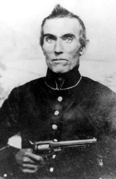 Old white man holding a revolver in military uniform