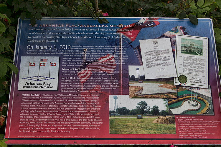"The Arkansas flag Webbaseka Memorial" interpretation panel with photographs on it and text