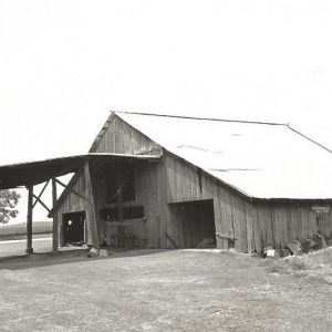 Large barn with canopy build onto it on farmstead