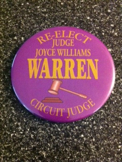 Purple campaign button with yellow text