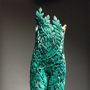 Green sculpture of legs and torso made from leaves