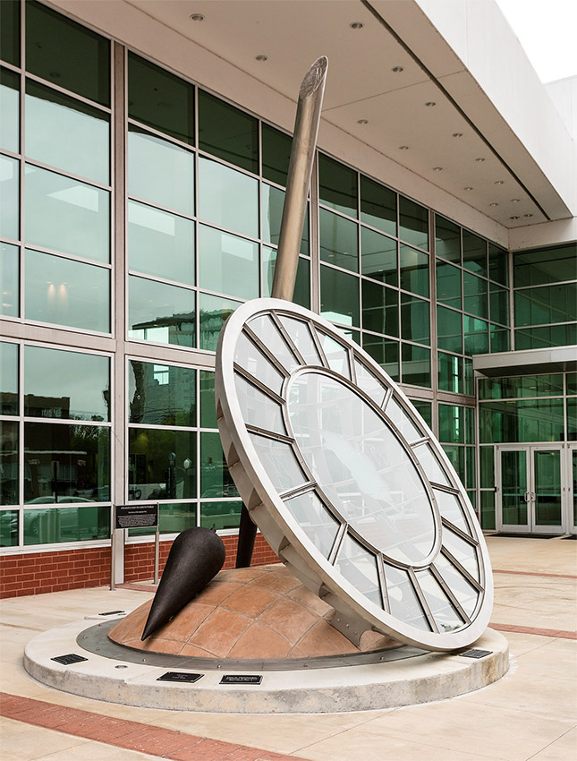 Round sculpture outdoors in front of windows