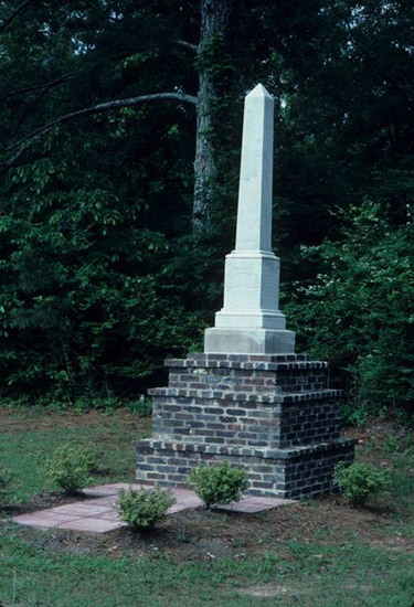 Obelisk shaped monument on three-tiered brick pedestal