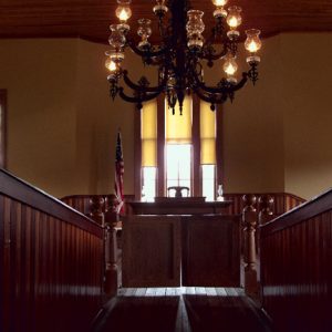 Court house interior with chandelier and wooden stands