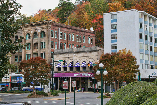 City street with tall buildings and two-story "wax museum"