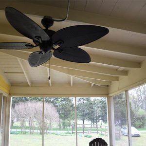 Interior of screened-in porch with ceiling fan and chairs