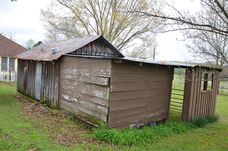 Wooden shed buildings in back yard outside house