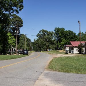 Single story buildings on two-lane road with power lines