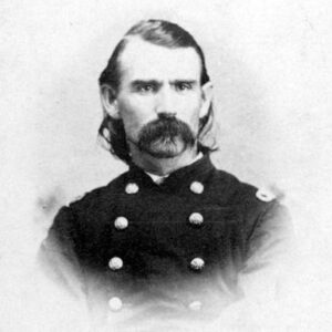 White man with long hair and long mustache in military uniform