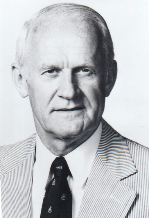 Older white man in striped suit and tie