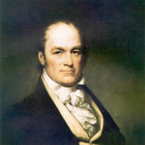 Portrait of white man with thinning hair slight smile in suit and cravat