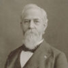 White man with long beard in suit with bow tie