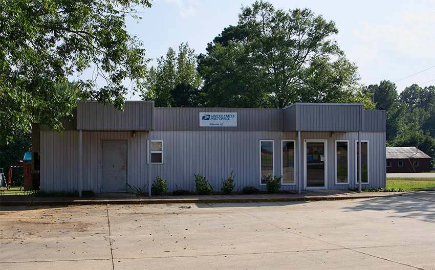Single-story building with covered entrances on parking lot