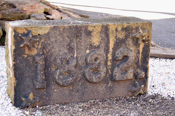 Stone with "1882" stamped on it