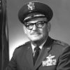 Old white man with mustache and glasses in military uniform