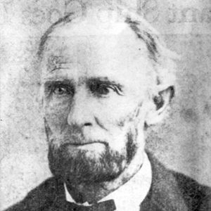 Old white man with beard in suit and bow tie